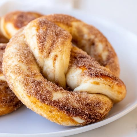Warm and fluffy cinnamon sugar pretzels, coated in a generous, sparkling sugar-cinnamon mix.