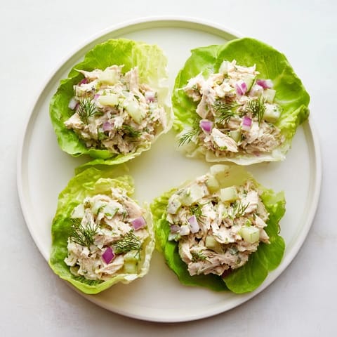 Tangy Dill Pickle Chicken Salad Lettuce Cups filled with shredded chicken, crunchy celery, and fresh dill, served chilled on refreshing green lettuce cups.