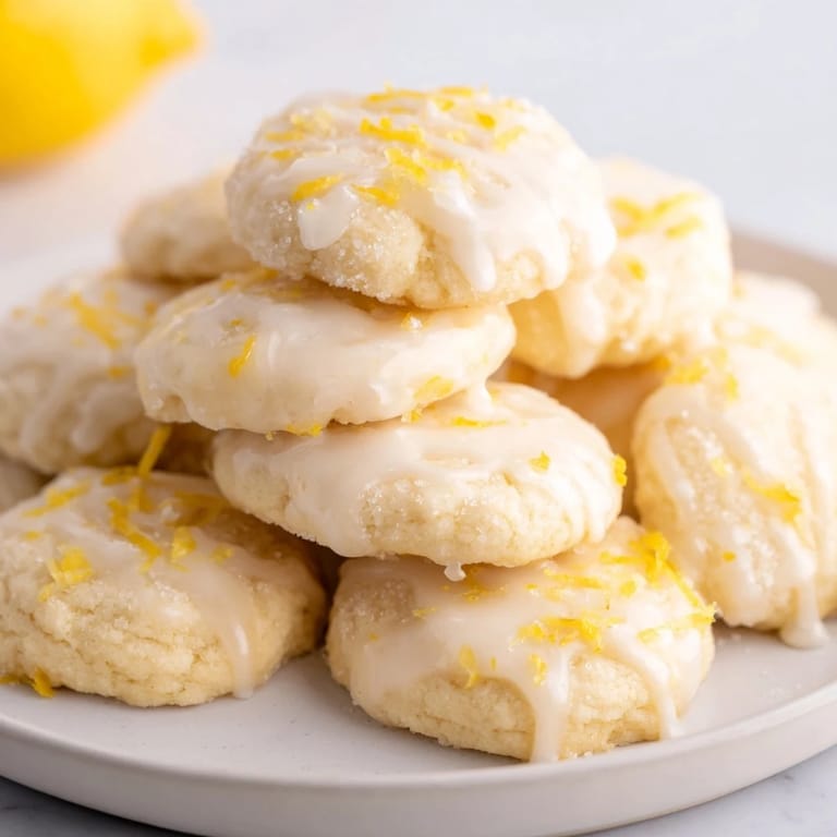 Close-up of soft Lemon Sugar Cookies dusted with sugar, perfect for a sunny afternoon tea.