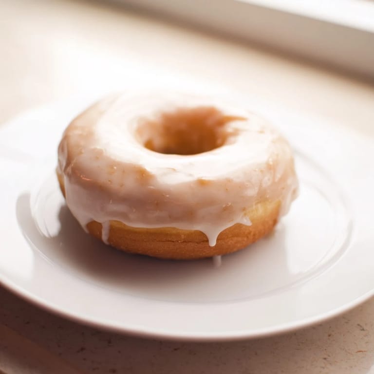Warm, soft yeast donuts with a sweet glaze, perfect for sharing and enjoying a delicious morning.