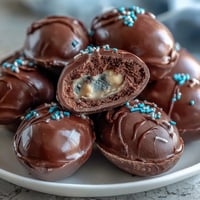 Homemade peanut butter Easter eggs coated in glossy chocolate, ready for festive springtime dessert.